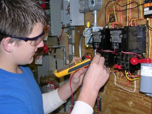 man testing wires t see if they wok